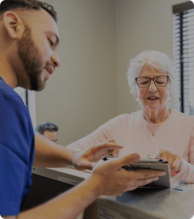 Nurse helping senior woman with paperwork