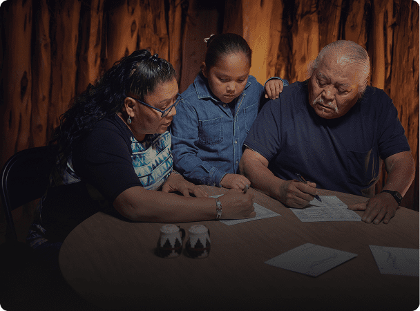 Family writing together at table