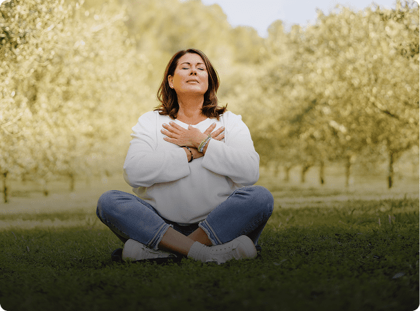 Woman meditating outdoors in serene setting
