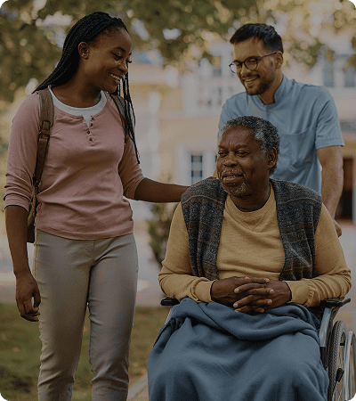 Caregivers with senior in a wheelchair.