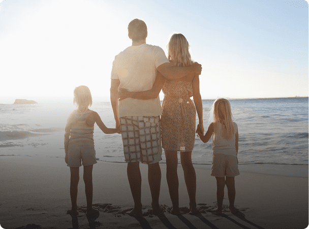 Parents and children at ocean's edge