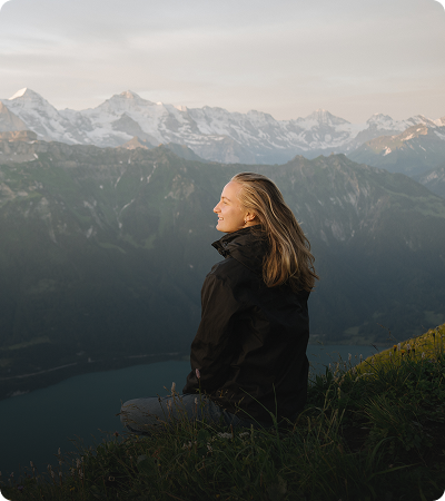 Woman enjoying mountain view at sunrise