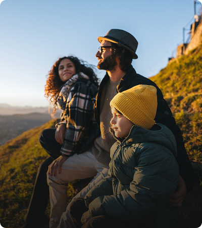 Parents and child sitting outdoors