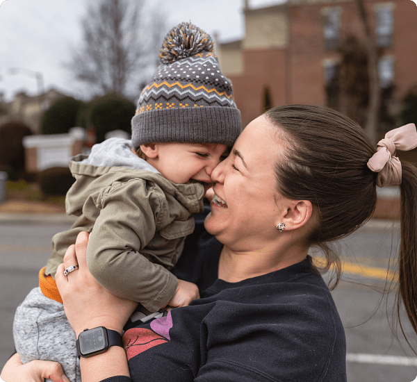 Happy toddler and mother nose to nose