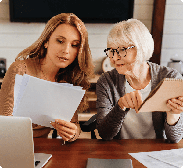 Women reviewing documents together at table