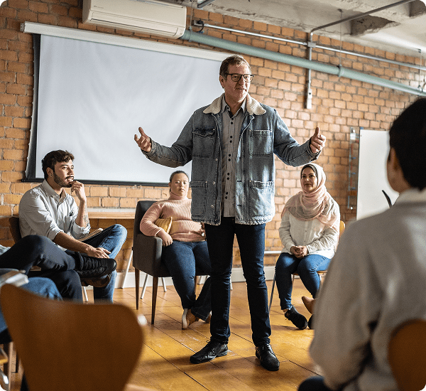 Man speaking to group in casual meeting