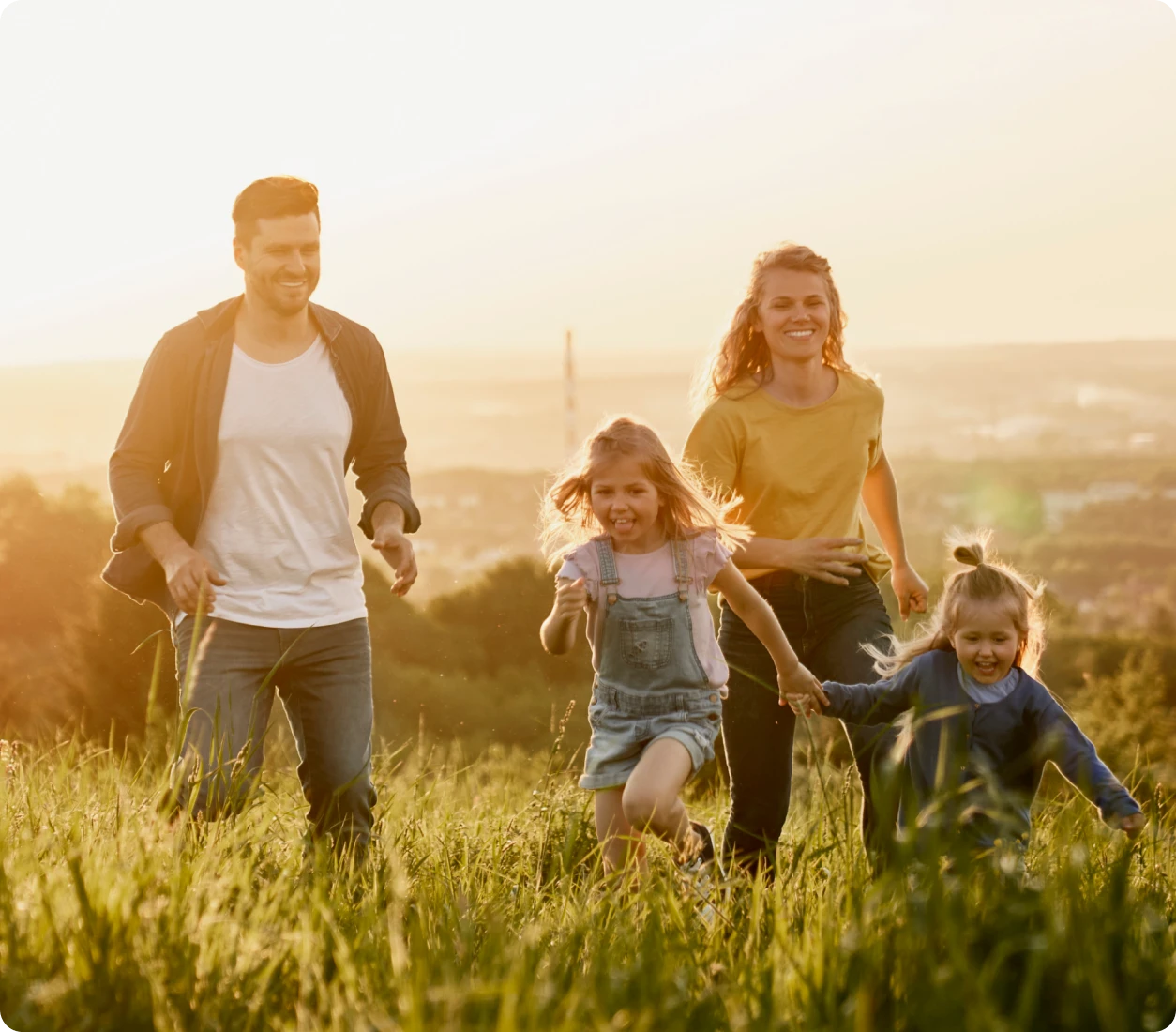 Happy family playing in grassy meadow
